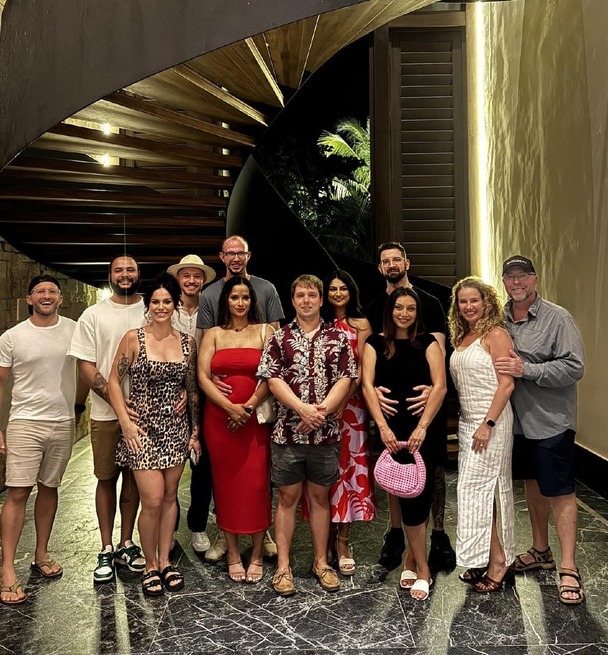 Josh, Chris and around a dozen friends at a luxury resort in the evening