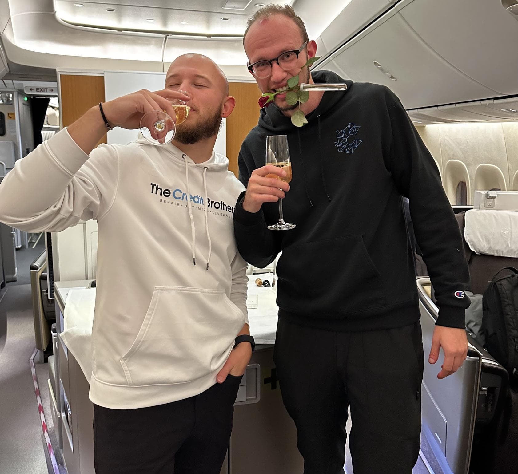 Josh and Chris Steil in The Credit Brothers hoodies, in a premium cabin